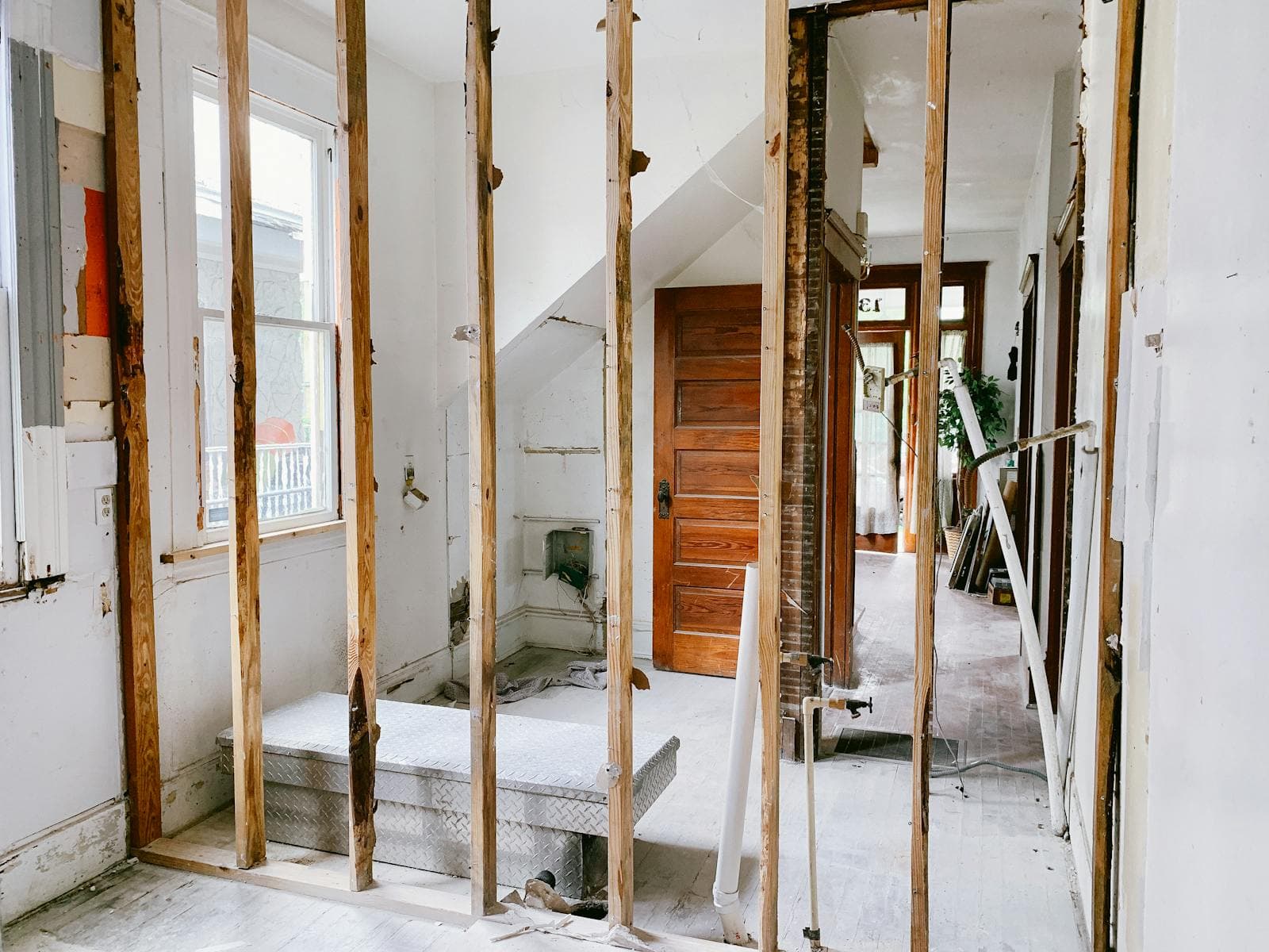 Wide interior shot of whole-home renovation in progress with multiple rooms visible